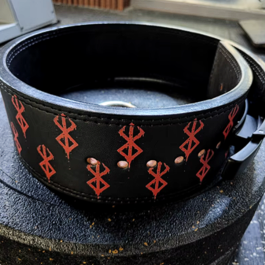 Cowhide powerlifting belt with steel buckle and red berserker design on black leather.