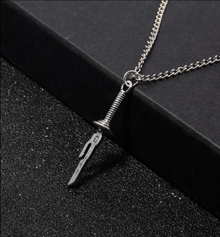 Jujutsu Kaisen Necklace featuring anime-inspired pendant on black surface.