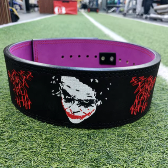 Joker embroidery weightlifting belt with lever buckle on grass.