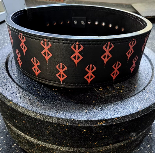 Berserk powerlifting belt with red patterns on black leather, robust steel buckle, designed for maximum support during workouts.