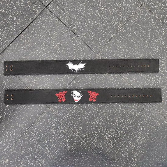 Joker Embroidery Powerlifting Belt with adjustable lever buckle on gym floor.